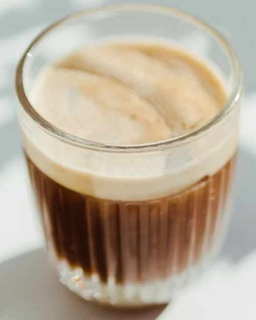 Espresso with crema in a small glass cup