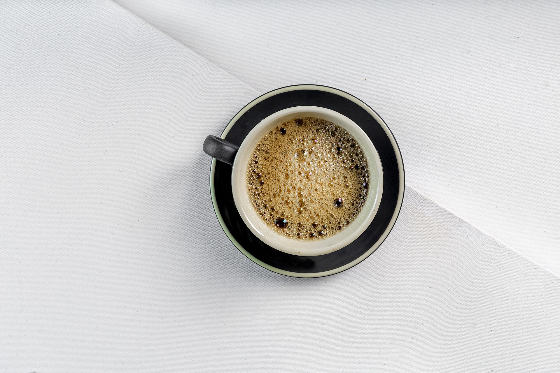 Fresh Italian espresso in a small cup, the base of a caffè corretto