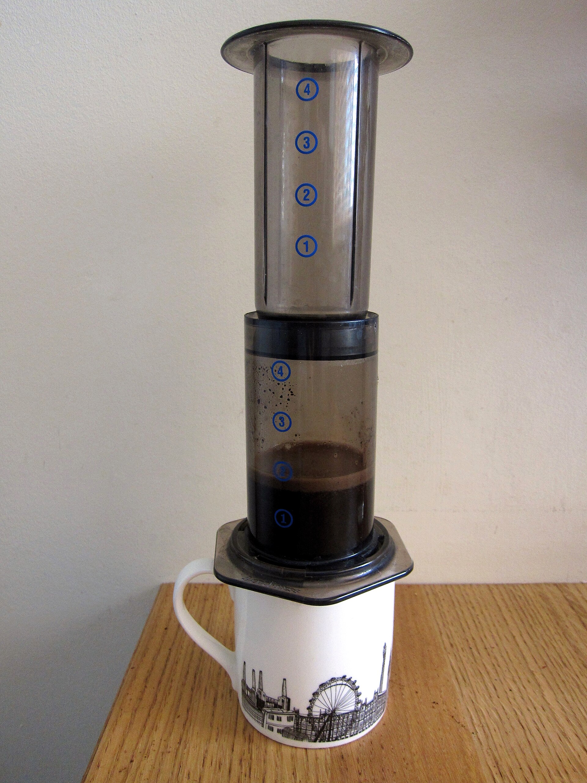 An AeroPress standing on a mug while brewing, a compact setup in the aeropress vs french press debate