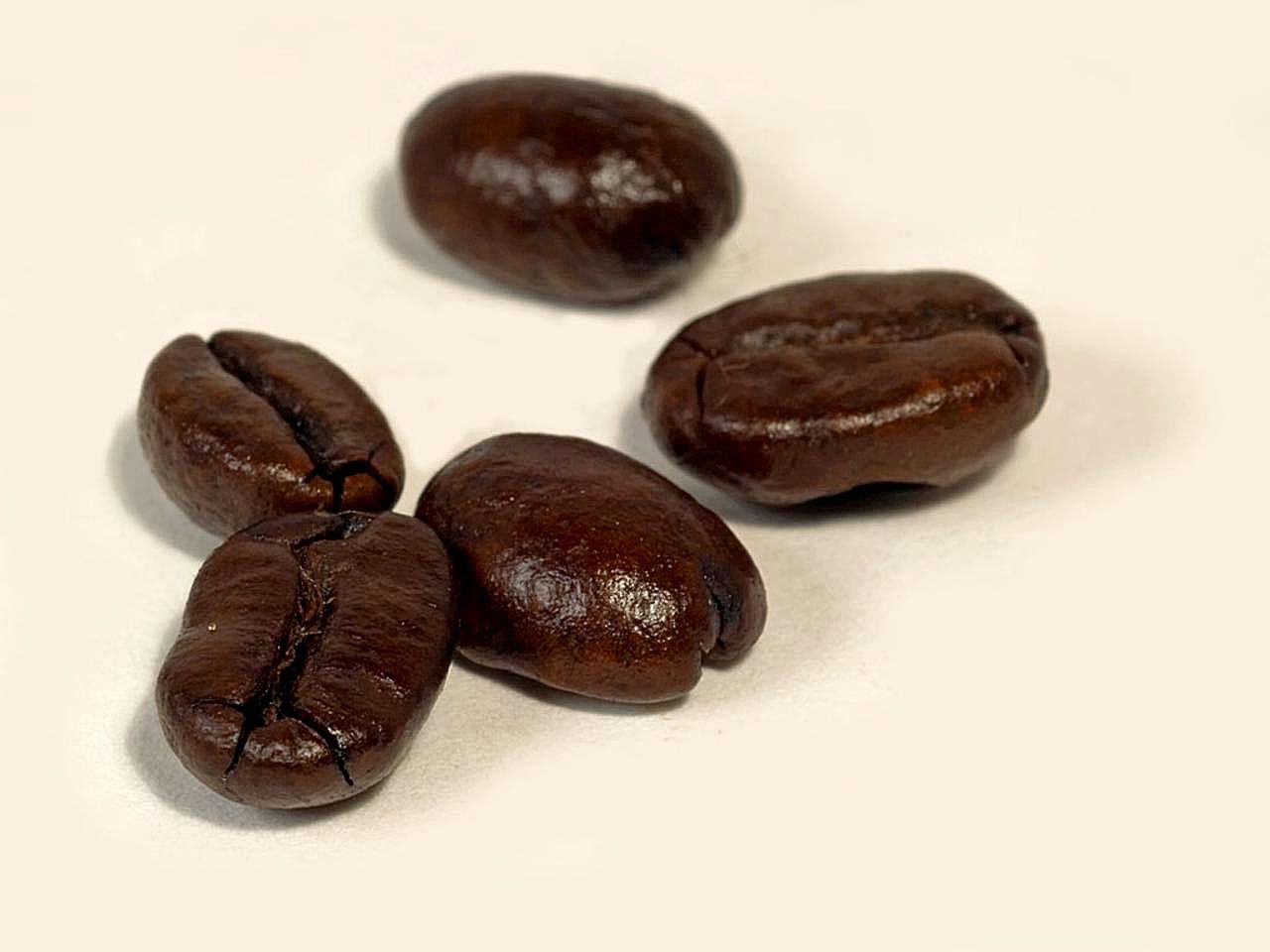 Dark roasted coffee beans, a common sign of strong coffee taste