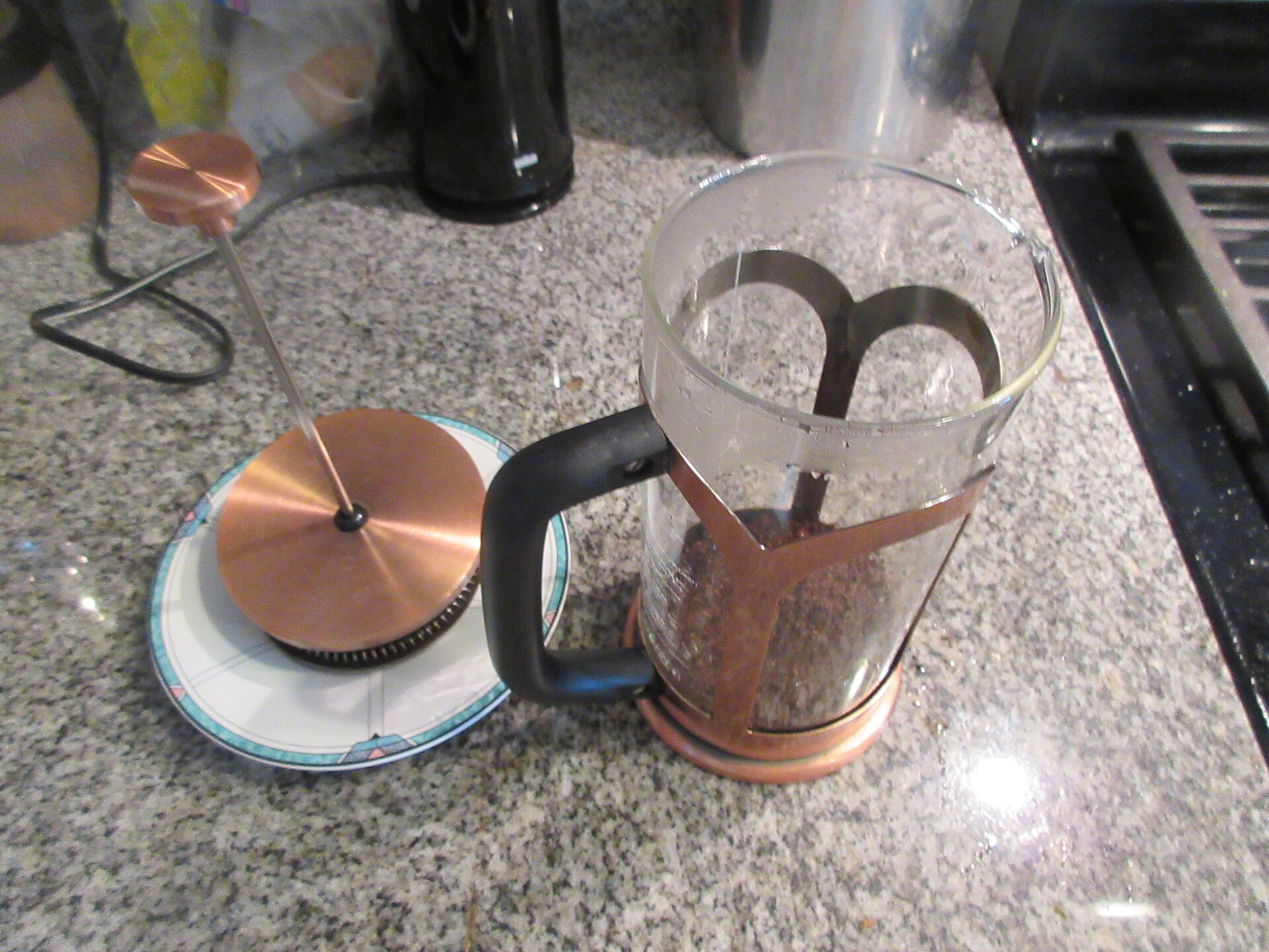 A glass French press brewing on a kitchen counter, the other side of the aeropress vs french press choice