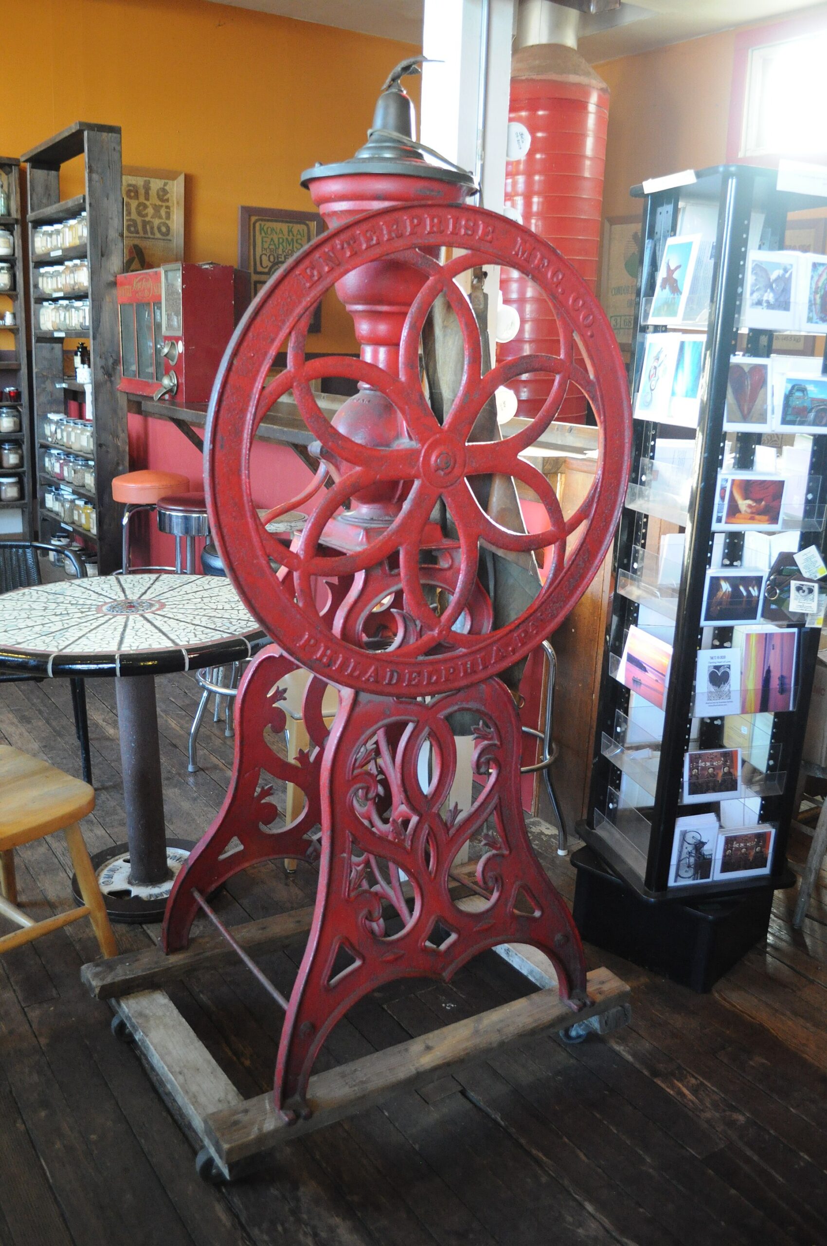 Old coffee grinder at a roastery, a reminder of how long hand grinding has lasted