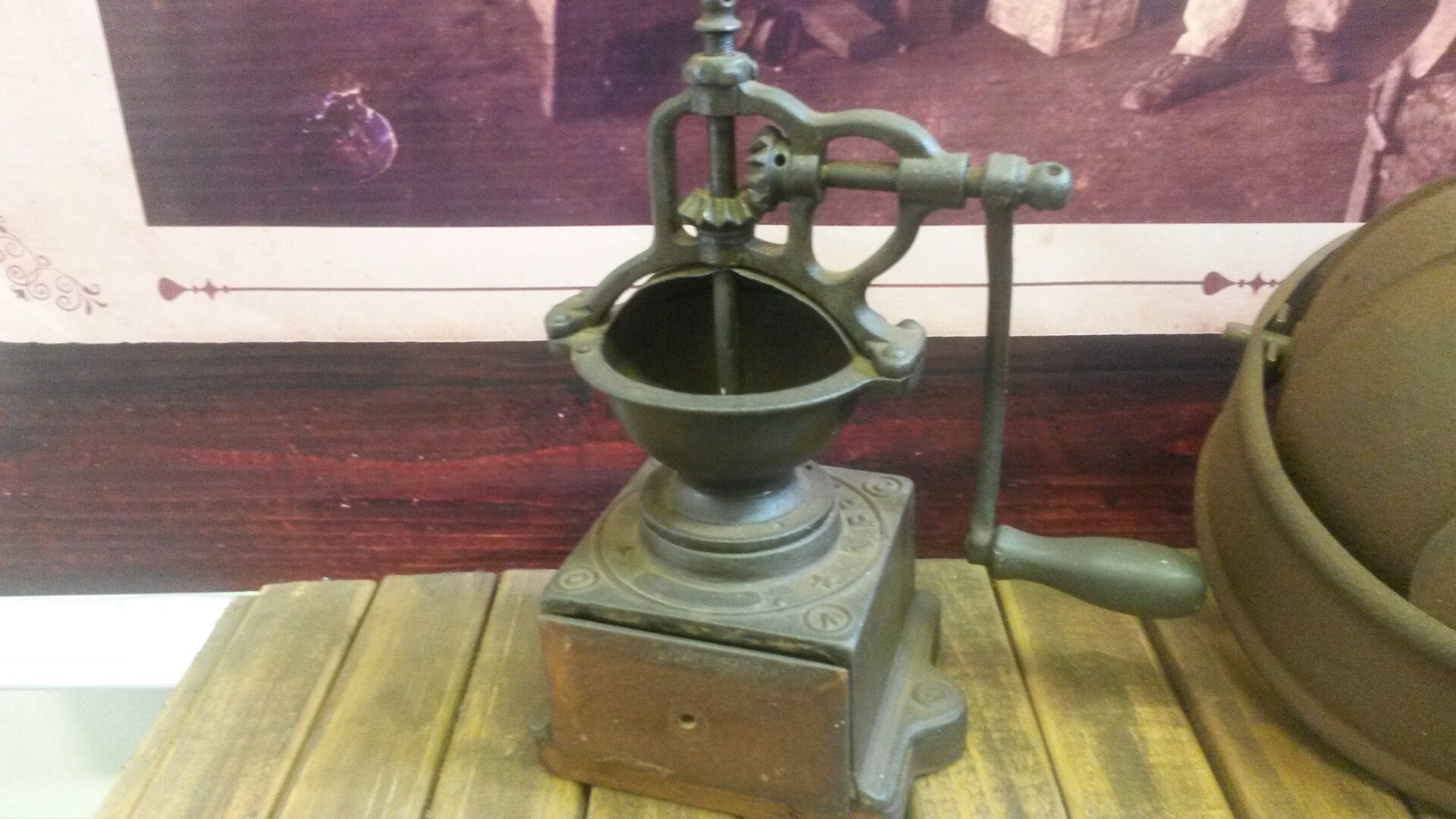A classic best manual coffee grinder style hand mill with a wooden base and crank
