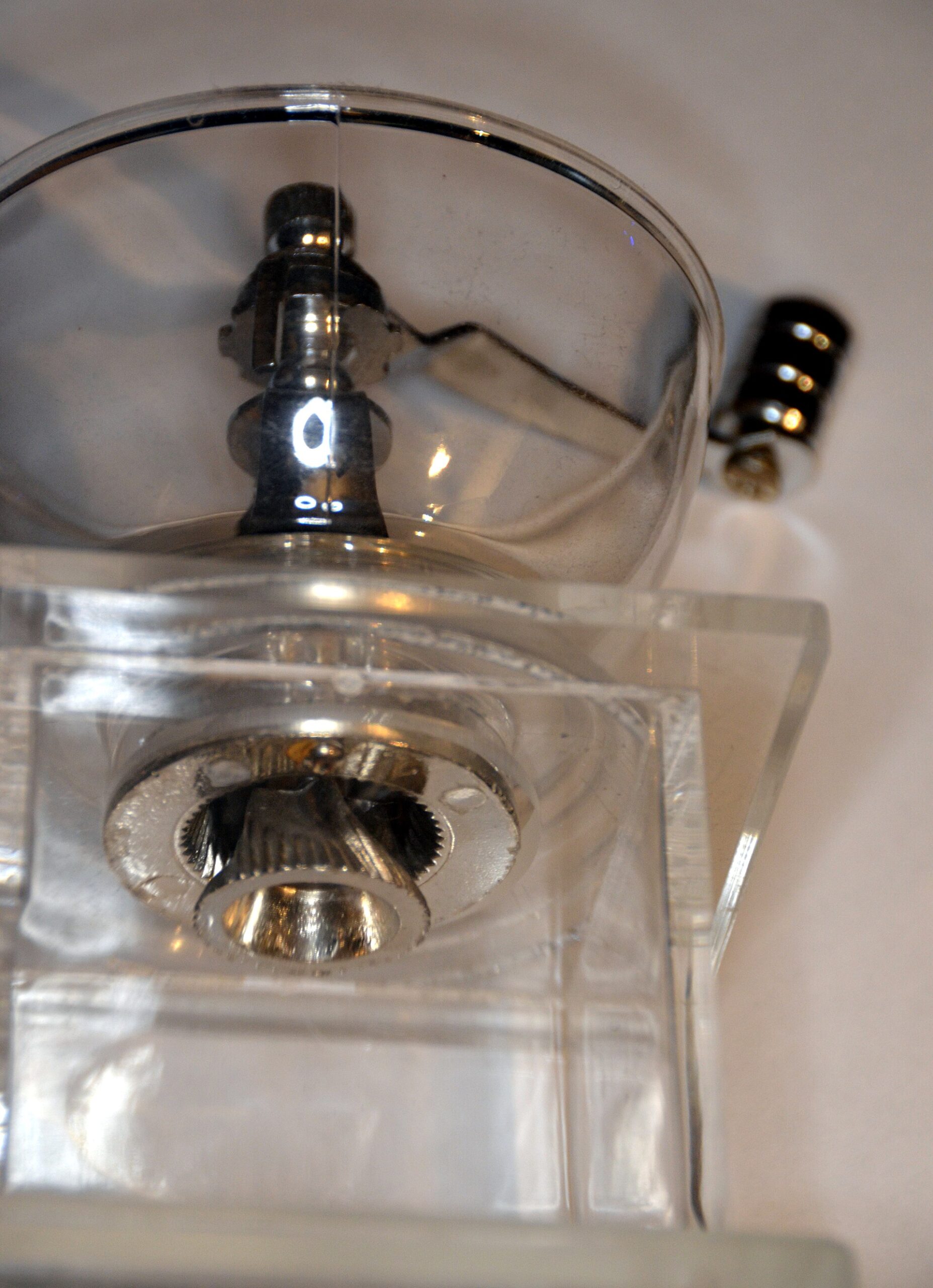 Manual coffee grinder mechanism showing how burrs crush coffee beans