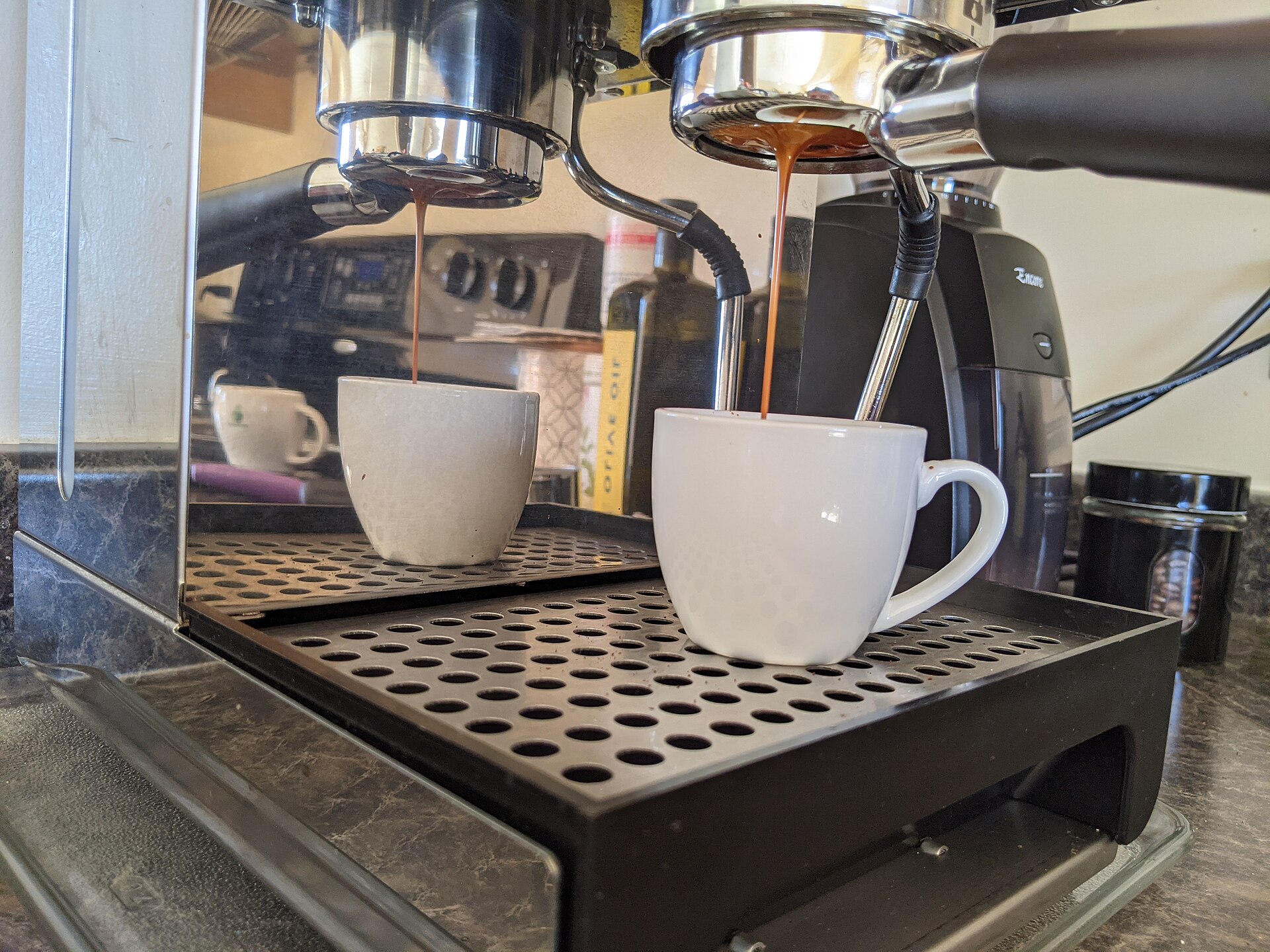 View from below of espresso streaming from a bottomless portafilter while you dial in espresso