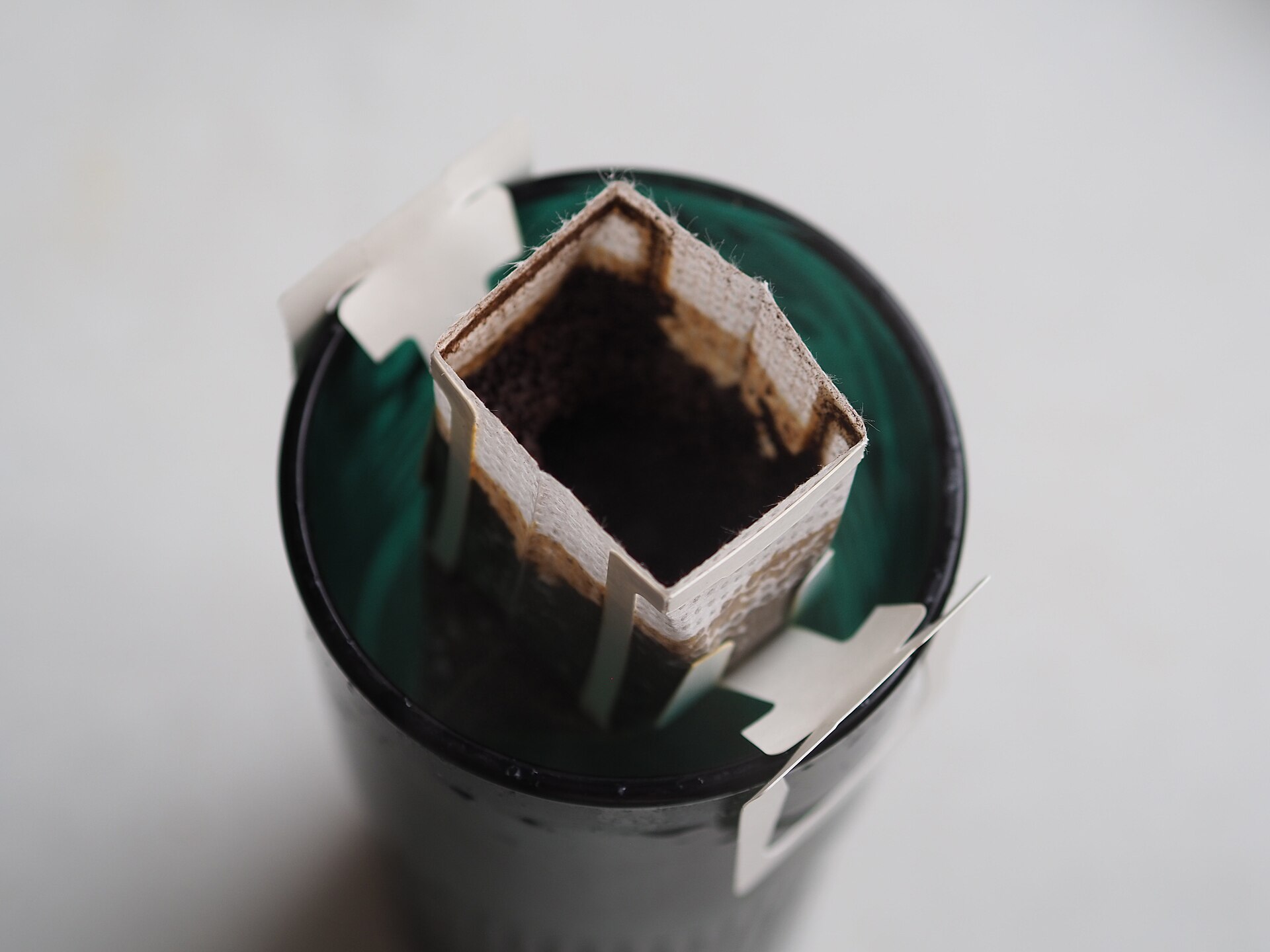 Hot water poured over ground coffee in a paper filter, the step where the best gooseneck kettles help most