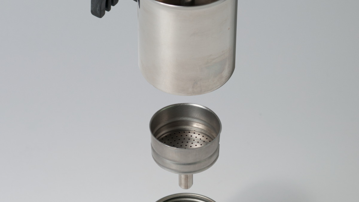 Moka pot parts disassembled: base, funnel filter and upper chamber