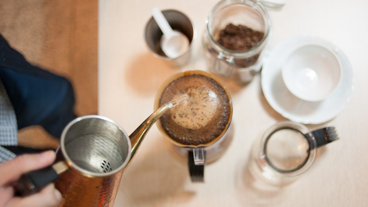 Manual drip brewing where a coffee scale tracks water weight