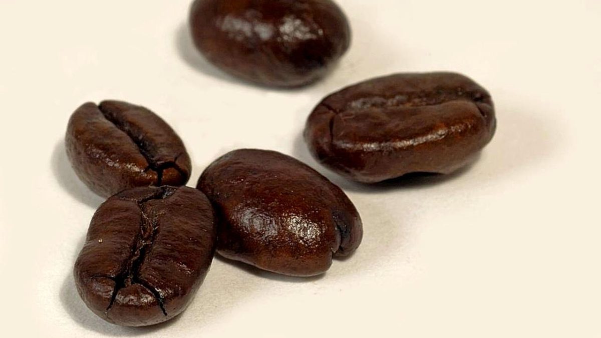 Dark roasted coffee beans, a common sign of strong coffee taste