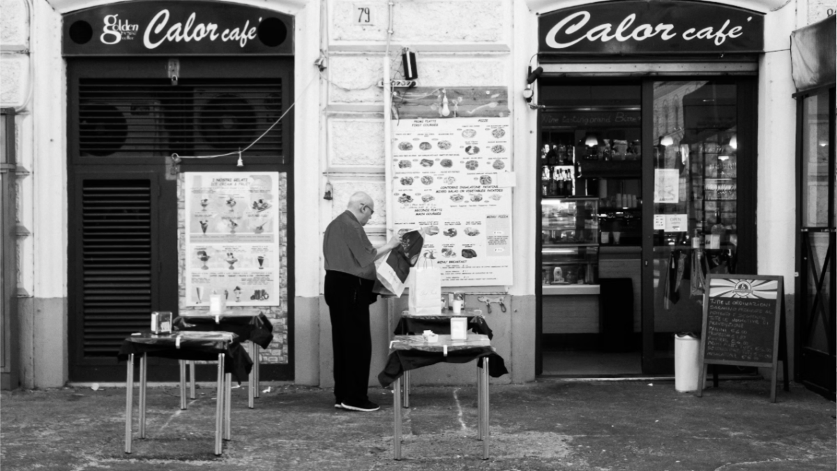 History of Italian espresso: an old neighborhood café bar with outdoor tables