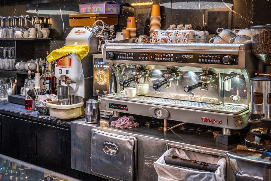 Espresso machine on the counter of a coffee bar in Rome, where Italian coffee drinks are ordered