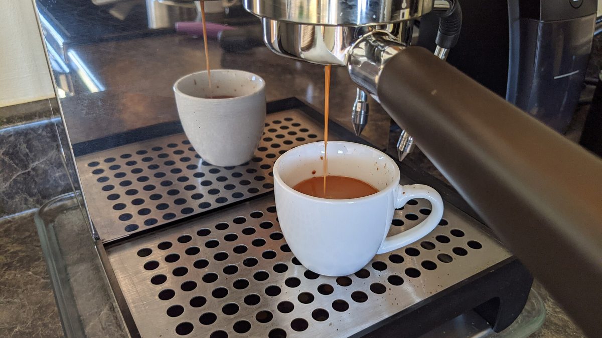 Espresso pouring from a naked portafilter during a dialed-in shot