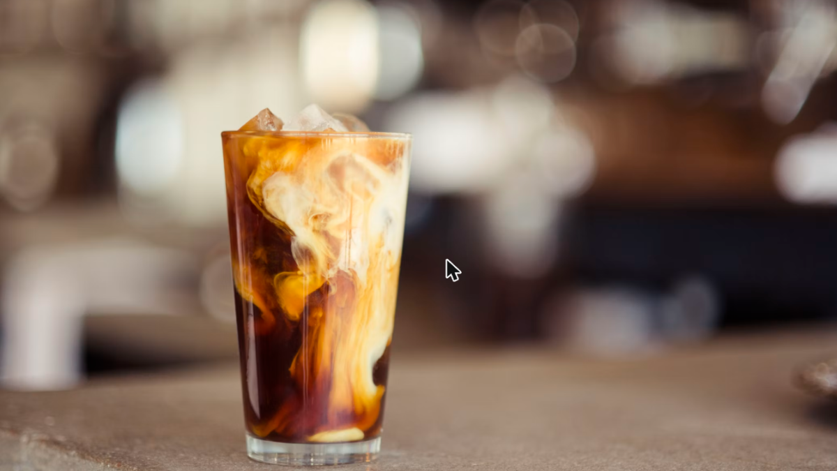 Caffè shakerato in a tall glass with foam, the classic Italian summer iced coffee