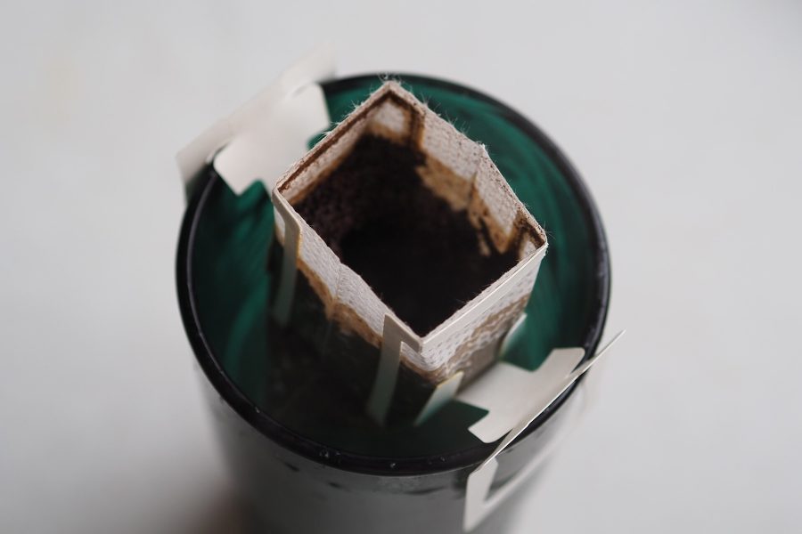 Hot water poured over ground coffee in a paper filter during a pour-over brew
