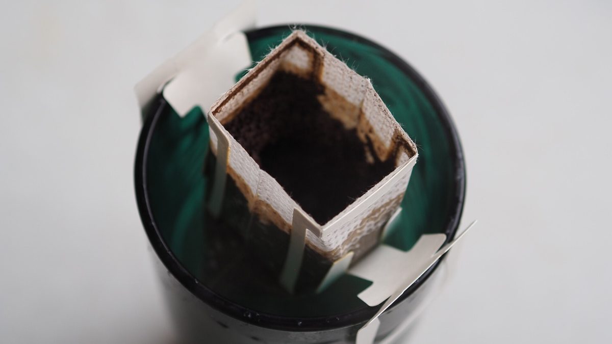 Hot water poured over ground coffee in a paper filter during a pour-over brew